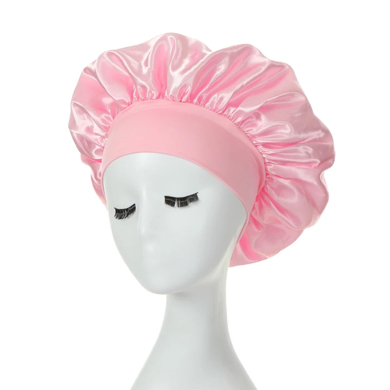 A pink silk bonnet on a mannequin head.