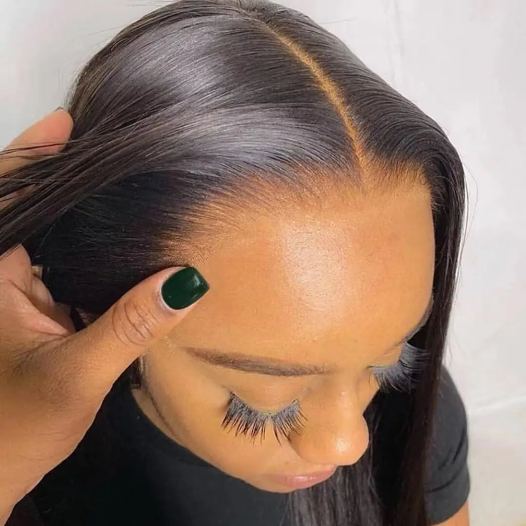 Person adjusting a Bone Straight Wig with a plain background