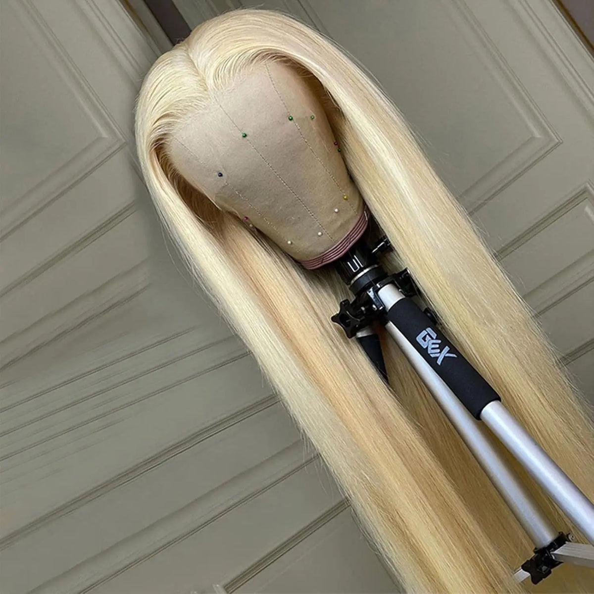 613 Bone Straight Wig on a mannequin head with a stand against a neutral background