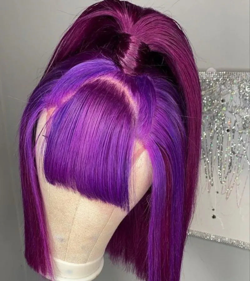 Purple bob wig on a canvas stand, styled with blunt bangs and a high half-up ponytail.